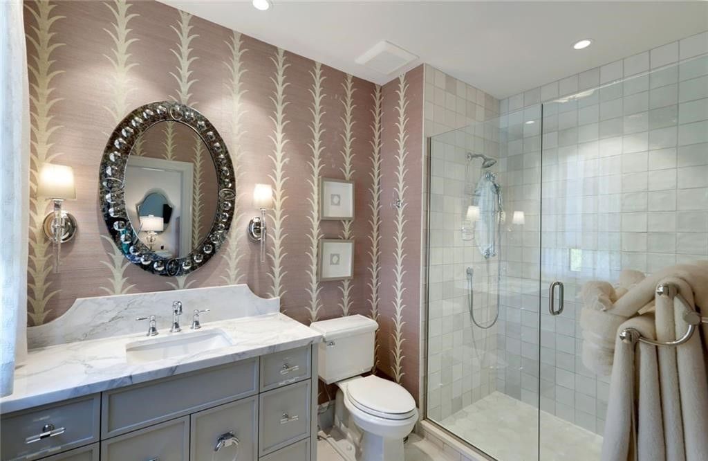 Set on nearly an acre in Audubon Country Club, this 4-bed, 6-bath home, designed by Renee Gaddis and built by the Williams Group, blends modern art deco with French countryside charm.