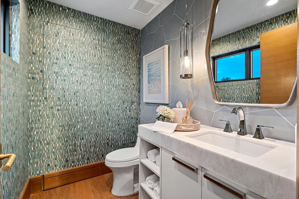 This modern Malibu-inspired estate in Boca Raton's exclusive Sanctuary community offers unparalleled luxury with 170 feet of protected waterfront.