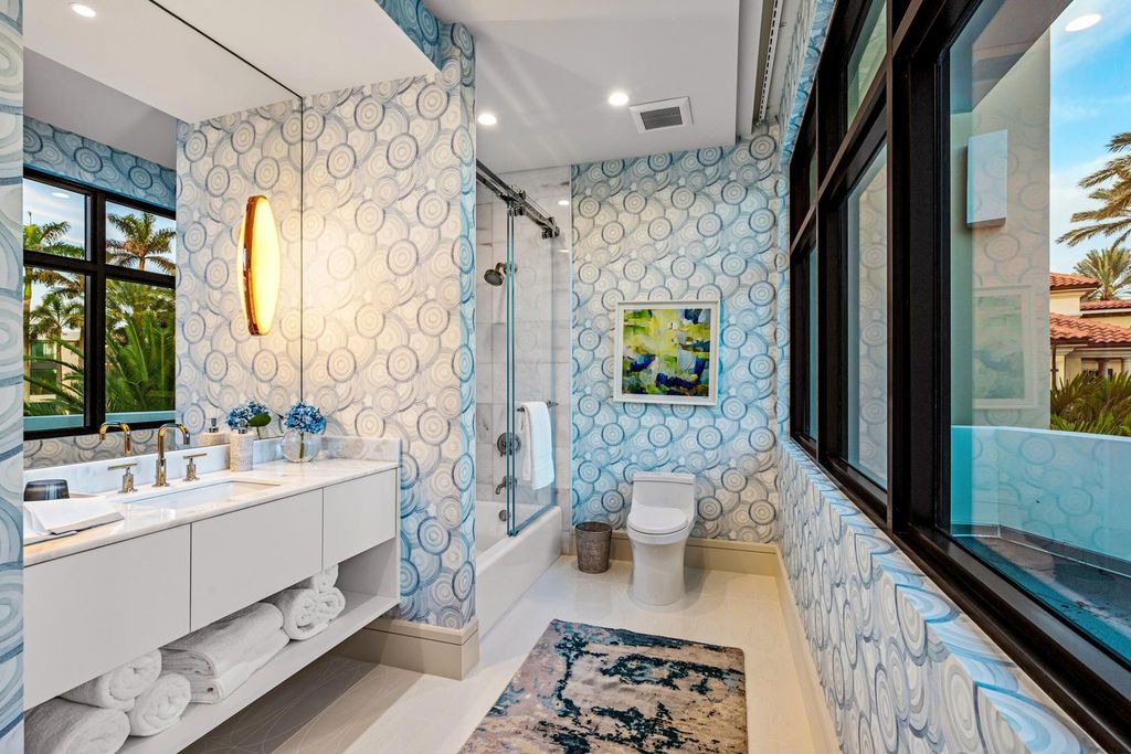 This modern Malibu-inspired estate in Boca Raton's exclusive Sanctuary community offers unparalleled luxury with 170 feet of protected waterfront.