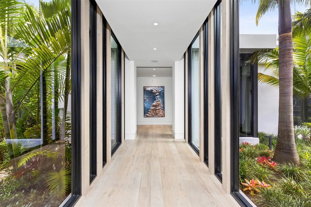 Experience unmatched luxury at 516 Mola Ave, a gated peninsula estate designed by Max Strang and built by Bomar Builders.