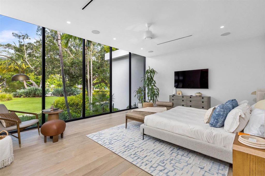 Experience unmatched luxury at 516 Mola Ave, a gated peninsula estate designed by Max Strang and built by Bomar Builders.