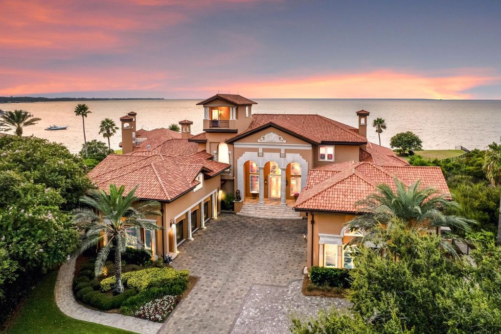 Featured on HGTV's Extreme Homes, this Tuscan-inspired masterpiece sits on a sprawling 1.87-acre lot, boasting over 400 feet of stunning water frontage along Choctawhatchee Bay and Jones Bayou.
