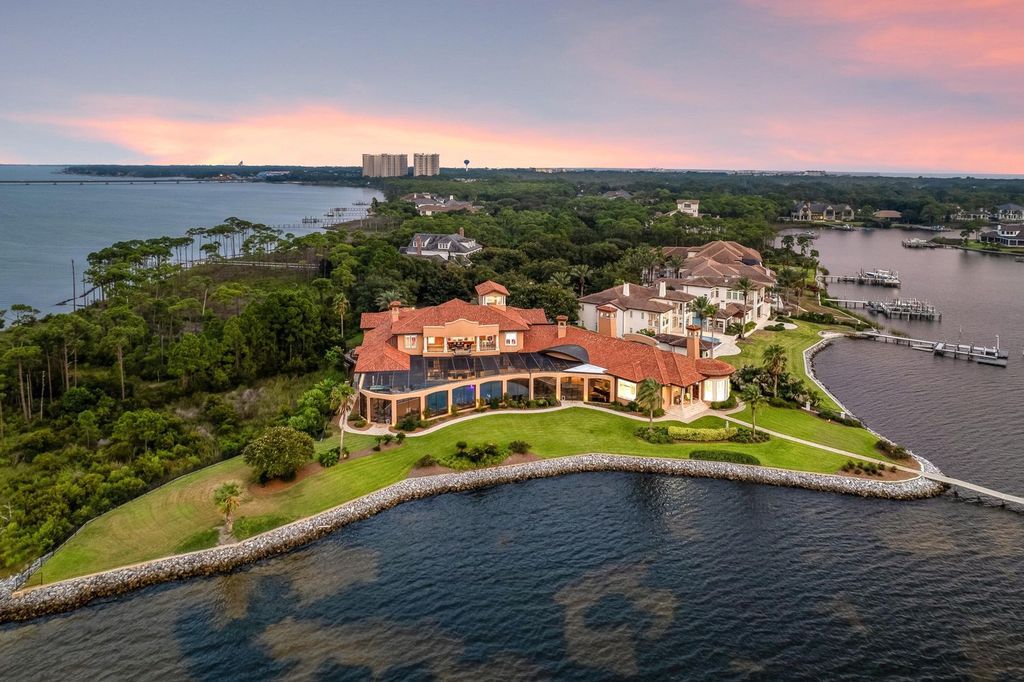 Featured on HGTV's Extreme Homes, this Tuscan-inspired masterpiece sits on a sprawling 1.87-acre lot, boasting over 400 feet of stunning water frontage along Choctawhatchee Bay and Jones Bayou.