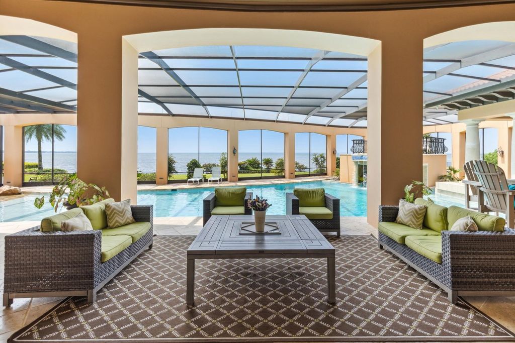 Featured on HGTV's Extreme Homes, this Tuscan-inspired masterpiece sits on a sprawling 1.87-acre lot, boasting over 400 feet of stunning water frontage along Choctawhatchee Bay and Jones Bayou.