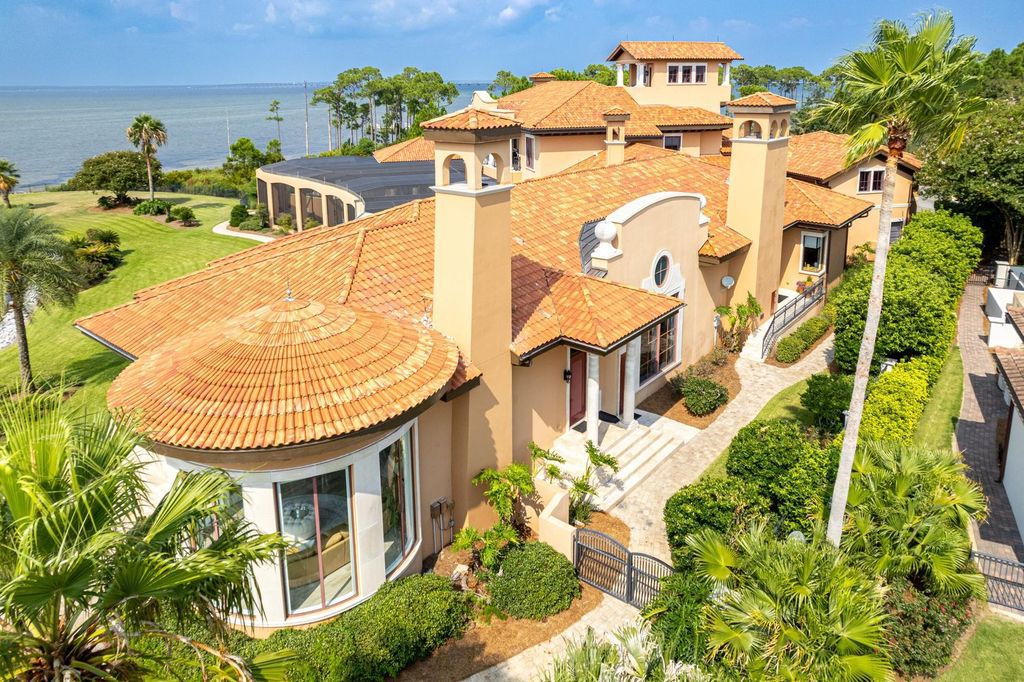 Featured on HGTV's Extreme Homes, this Tuscan-inspired masterpiece sits on a sprawling 1.87-acre lot, boasting over 400 feet of stunning water frontage along Choctawhatchee Bay and Jones Bayou.