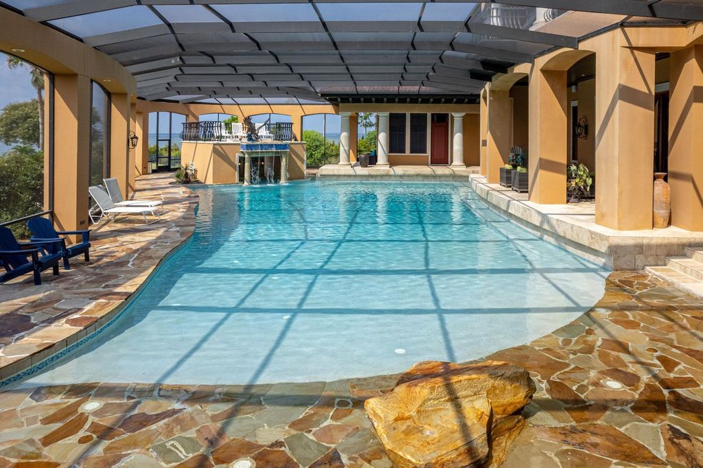 Featured on HGTV's Extreme Homes, this Tuscan-inspired masterpiece sits on a sprawling 1.87-acre lot, boasting over 400 feet of stunning water frontage along Choctawhatchee Bay and Jones Bayou.