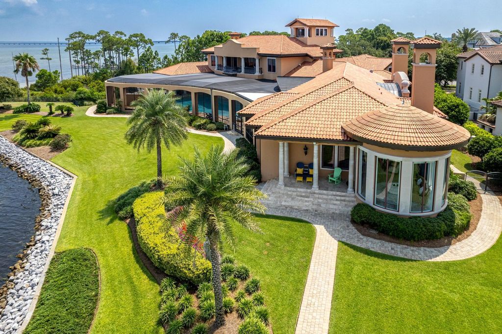 Featured on HGTV's Extreme Homes, this Tuscan-inspired masterpiece sits on a sprawling 1.87-acre lot, boasting over 400 feet of stunning water frontage along Choctawhatchee Bay and Jones Bayou.