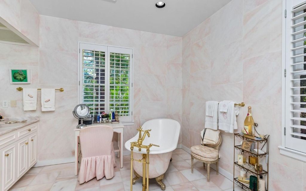 This exceptional 6BR/6.3BA Monterey-Style estate by Howard Major is a rare find on Palm Beach's exclusive El Bravo Way.