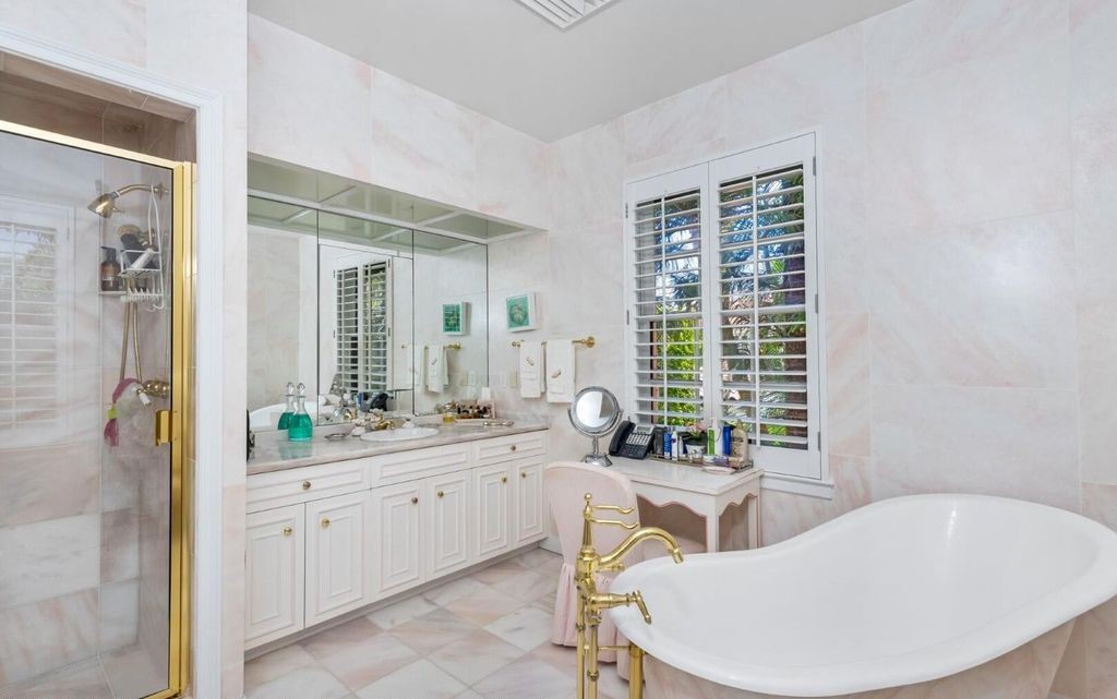 This exceptional 6BR/6.3BA Monterey-Style estate by Howard Major is a rare find on Palm Beach's exclusive El Bravo Way.