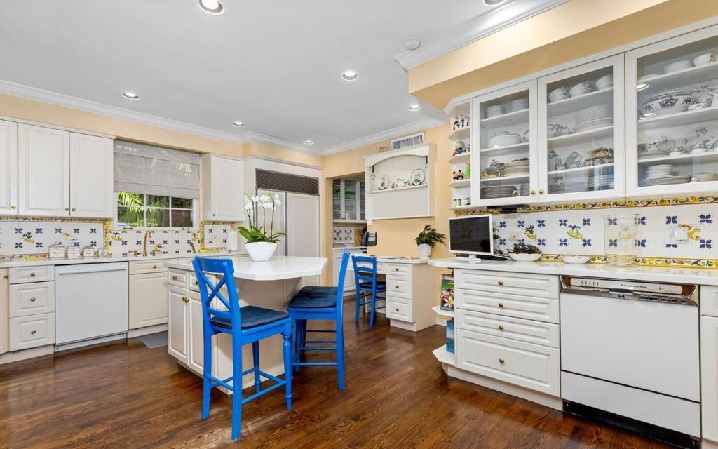 This exceptional 6BR/6.3BA Monterey-Style estate by Howard Major is a rare find on Palm Beach's exclusive El Bravo Way.