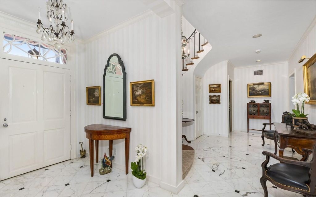 This exceptional 6BR/6.3BA Monterey-Style estate by Howard Major is a rare find on Palm Beach's exclusive El Bravo Way.