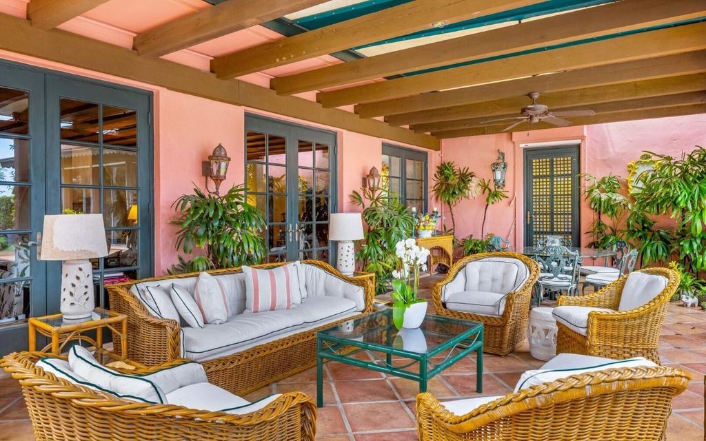 This exceptional 6BR/6.3BA Monterey-Style estate by Howard Major is a rare find on Palm Beach's exclusive El Bravo Way.
