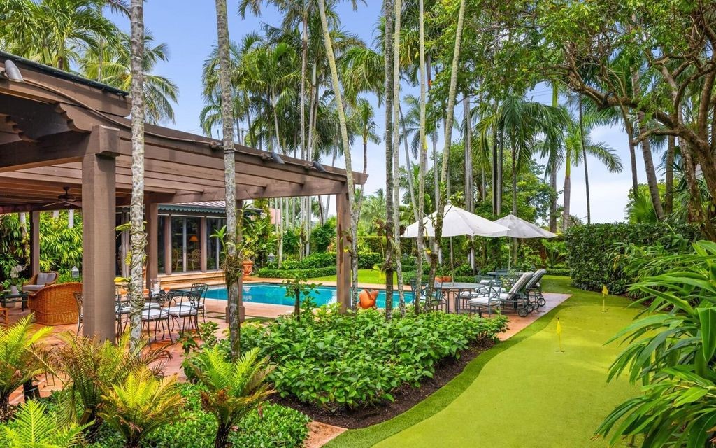 This exceptional 6BR/6.3BA Monterey-Style estate by Howard Major is a rare find on Palm Beach's exclusive El Bravo Way.