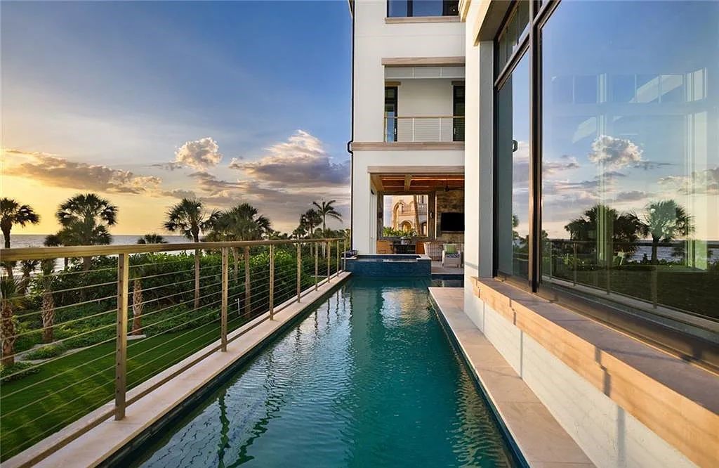 Nestled in the exclusive Strand at Bay Colony, this newly constructed 2023 custom home offers 5 bedrooms, 6 baths, and 7,210 square feet of refined living space on a 0.60-acre beachfront lot.