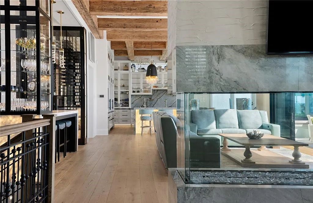 Nestled in the exclusive Strand at Bay Colony, this newly constructed 2023 custom home offers 5 bedrooms, 6 baths, and 7,210 square feet of refined living space on a 0.60-acre beachfront lot.