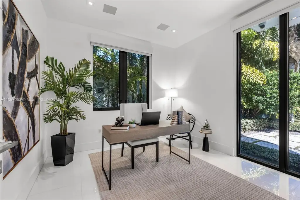 Spacious living area at 124 Park Dr, Bal Harbour, with floor-to-ceiling windows and an elegant open layout.