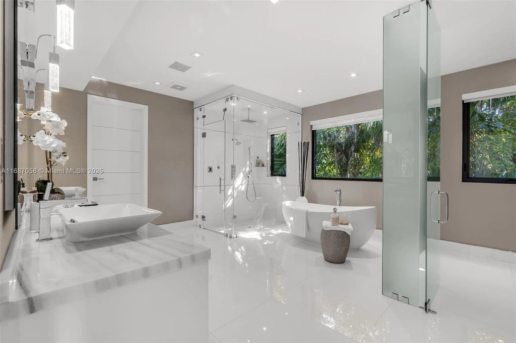 Spacious living area at 124 Park Dr, Bal Harbour, with floor-to-ceiling windows and an elegant open layout.