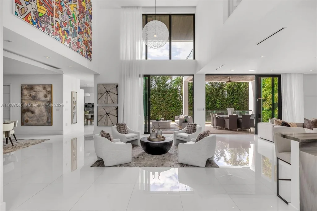 Spacious living area at 124 Park Dr, Bal Harbour, with floor-to-ceiling windows and an elegant open layout.