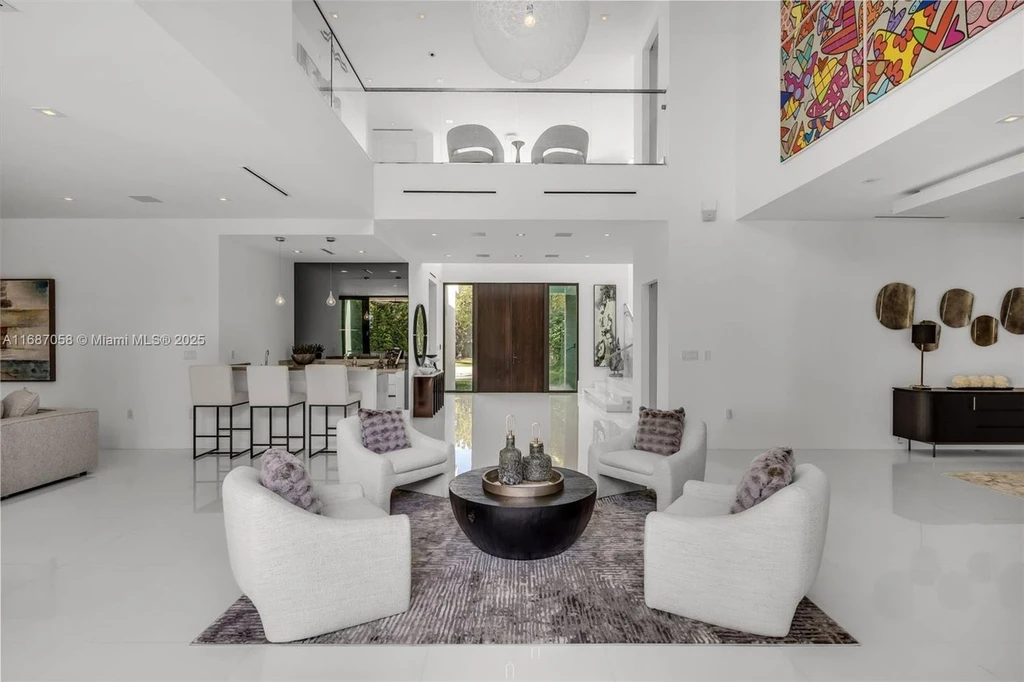 Spacious living area at 124 Park Dr, Bal Harbour, with floor-to-ceiling windows and an elegant open layout.
