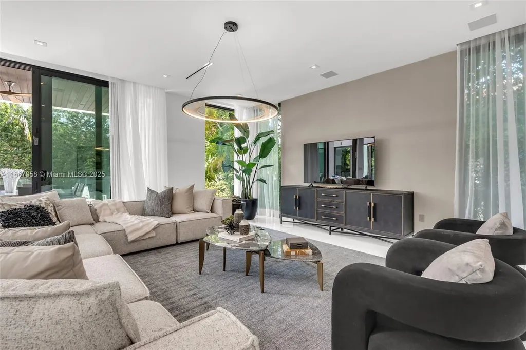 Spacious living area at 124 Park Dr, Bal Harbour, with floor-to-ceiling windows and an elegant open layout.