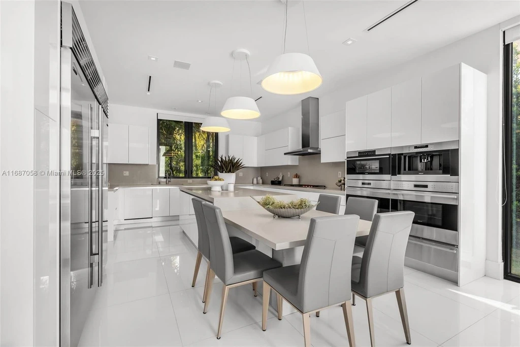 Spacious living area at 124 Park Dr, Bal Harbour, with floor-to-ceiling windows and an elegant open layout.