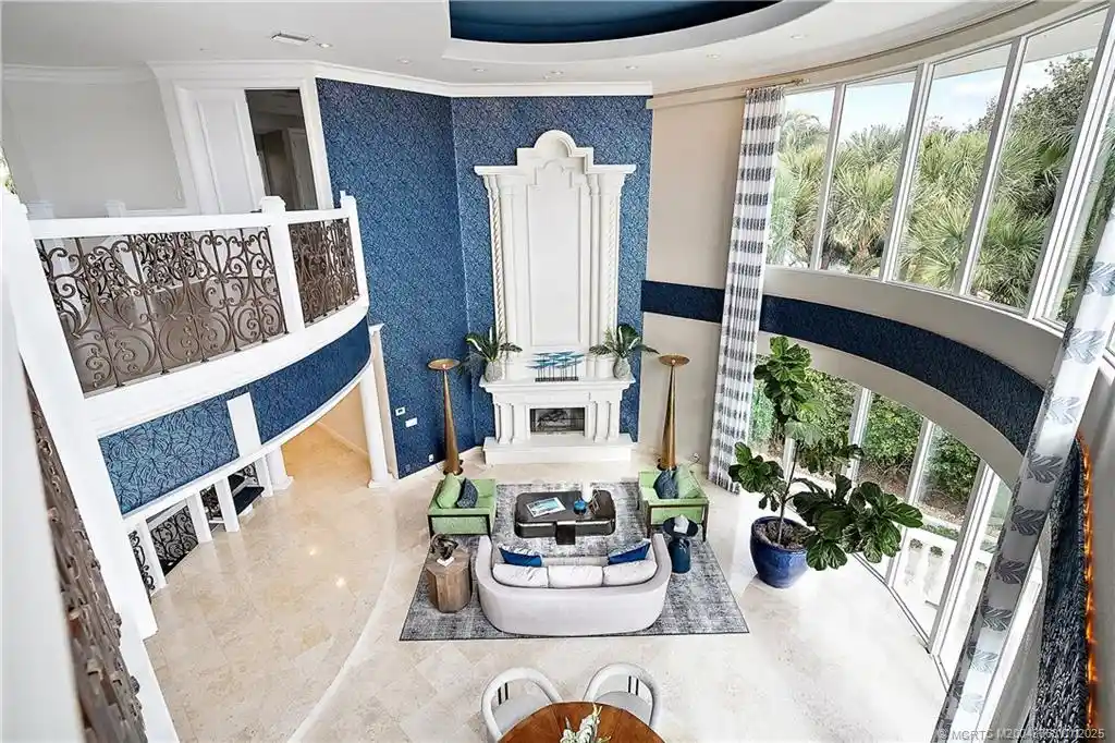 Luxurious waterfront estate in Sewalls Point featuring panoramic water views, resort-style pool, private boat lifts, and elegant architectural design. Perfect Sewalls Pt home for sale with 6 bedrooms, 7 baths, and modern amenities.