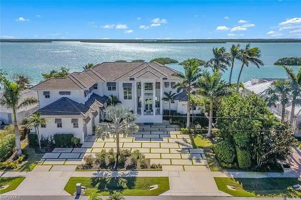 Stunning waterfront estate at 1829 S Inlet Dr, Marco Island, featuring a contemporary coastal design with panoramic Gulf views and lush tropical landscaping.