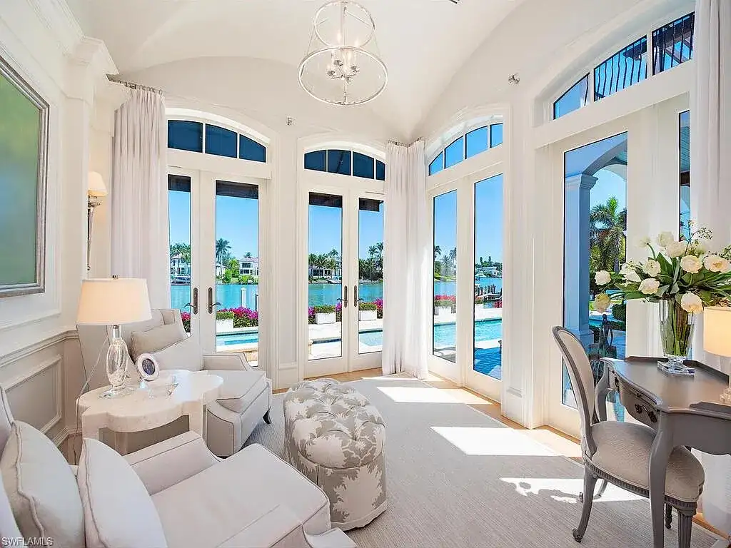 Front exterior view of 3565 Fort Charles Dr, a stunning waterfront Naples home for sale in Port Royal