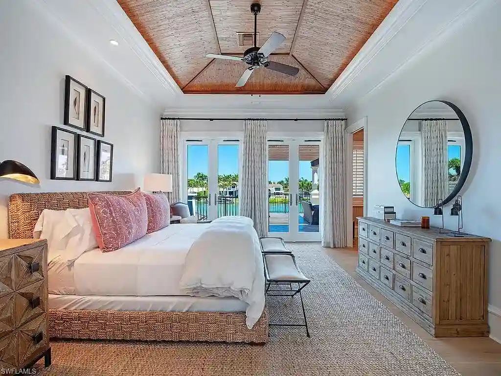 Front exterior view of 3565 Fort Charles Dr, a stunning waterfront Naples home for sale in Port Royal