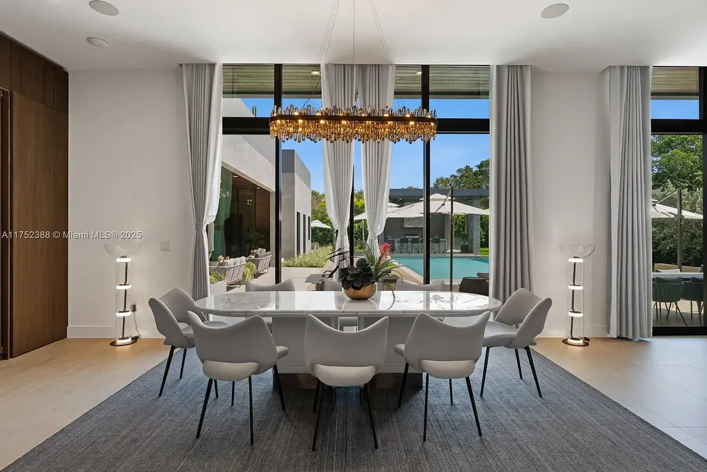 Luxury modern estate at 5900 SW 129th Terrace, Pinecrest, FL – a $17.99M newly built home featuring a pristine pool, private gym, immersive theater, and elegant open kitchen.