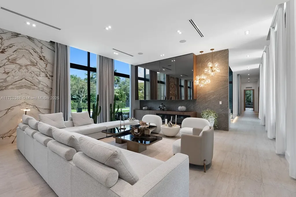 Luxury modern estate at 5900 SW 129th Terrace, Pinecrest, FL – a $17.99M newly built home featuring a pristine pool, private gym, immersive theater, and elegant open kitchen.