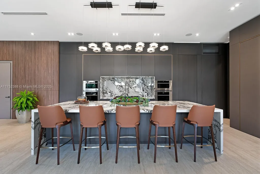 Luxury modern estate at 5900 SW 129th Terrace, Pinecrest, FL – a $17.99M newly built home featuring a pristine pool, private gym, immersive theater, and elegant open kitchen.