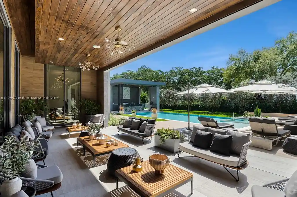 Luxury modern estate at 5900 SW 129th Terrace, Pinecrest, FL – a $17.99M newly built home featuring a pristine pool, private gym, immersive theater, and elegant open kitchen.