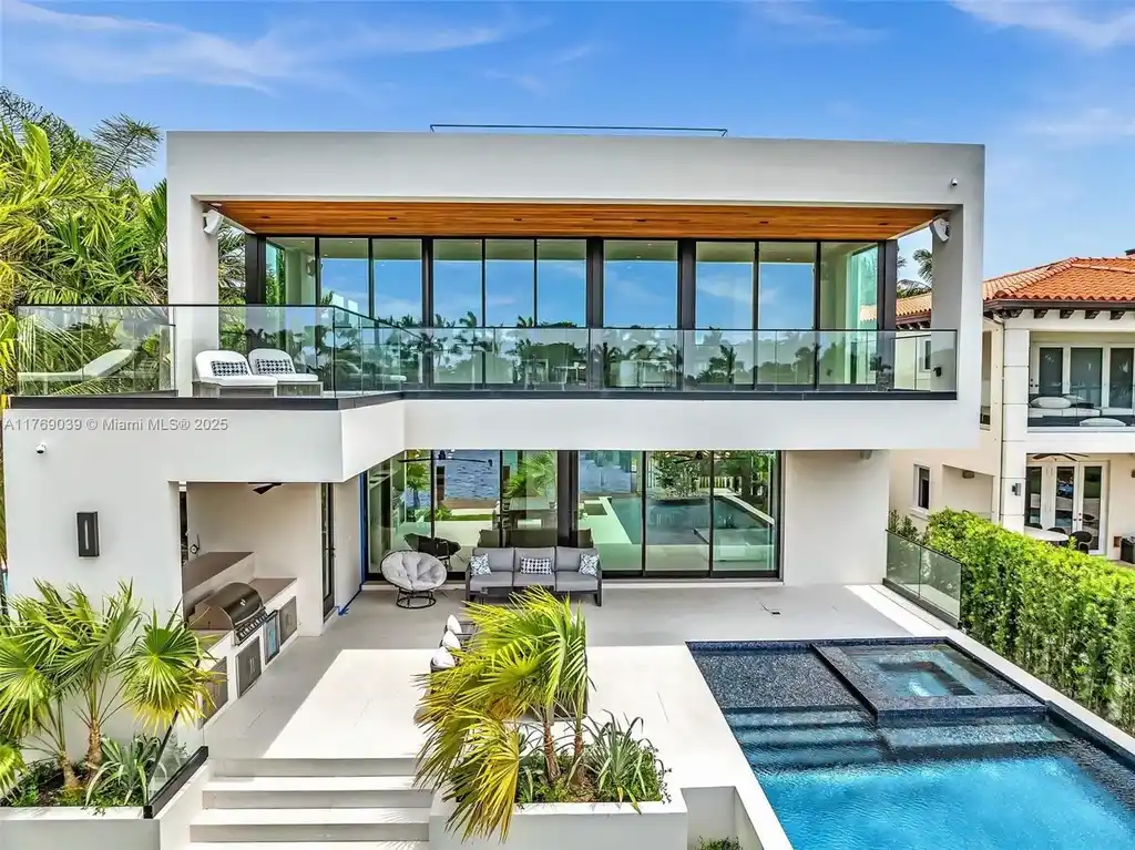 Open-concept living area with floor-to-ceiling windows at 9056 Bay Dr Surfside home for sale
