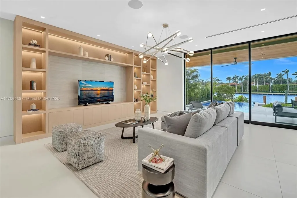 Open-concept living area with floor-to-ceiling windows at 9056 Bay Dr Surfside home for sale