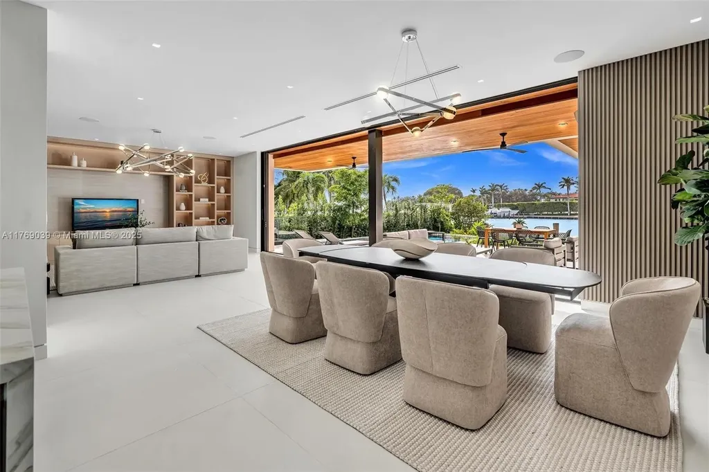 Open-concept living area with floor-to-ceiling windows at 9056 Bay Dr Surfside home for sale