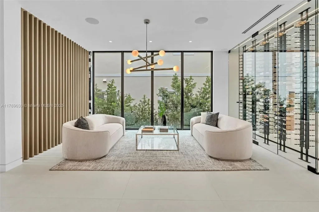 Open-concept living area with floor-to-ceiling windows at 9056 Bay Dr Surfside home for sale