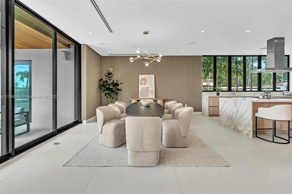 Open-concept living area with floor-to-ceiling windows at 9056 Bay Dr Surfside home for sale