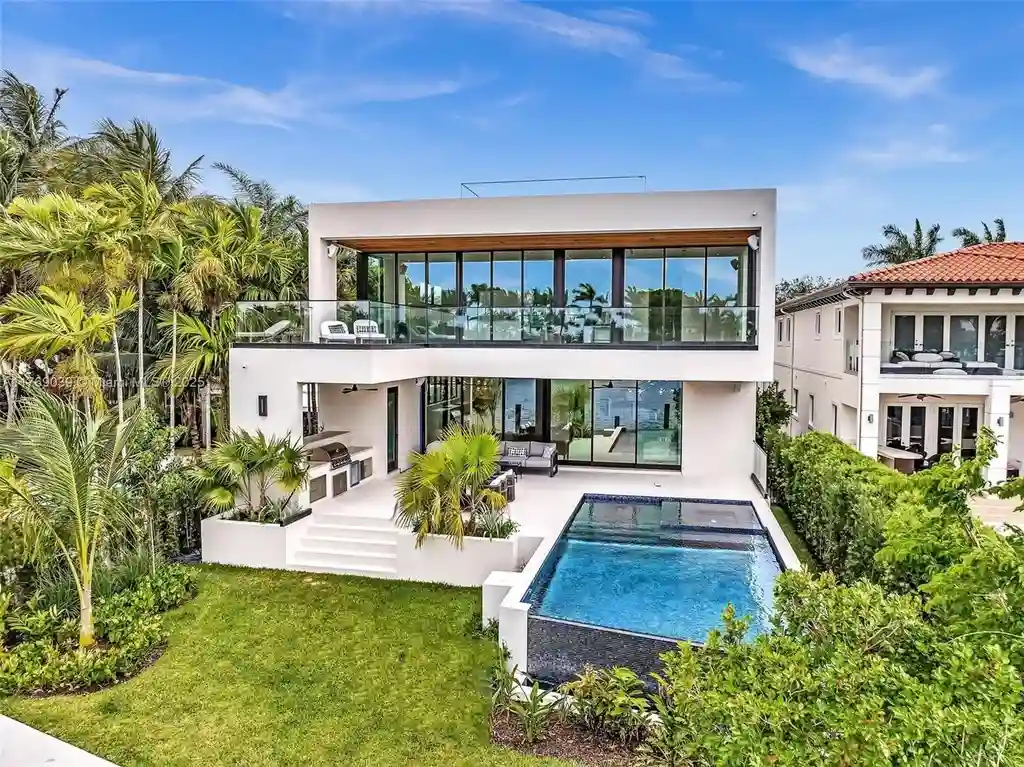 Open-concept living area with floor-to-ceiling windows at 9056 Bay Dr Surfside home for sale