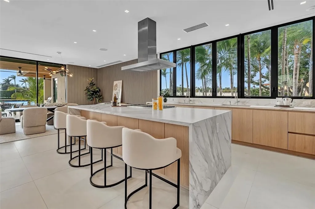 Open-concept living area with floor-to-ceiling windows at 9056 Bay Dr Surfside home for sale