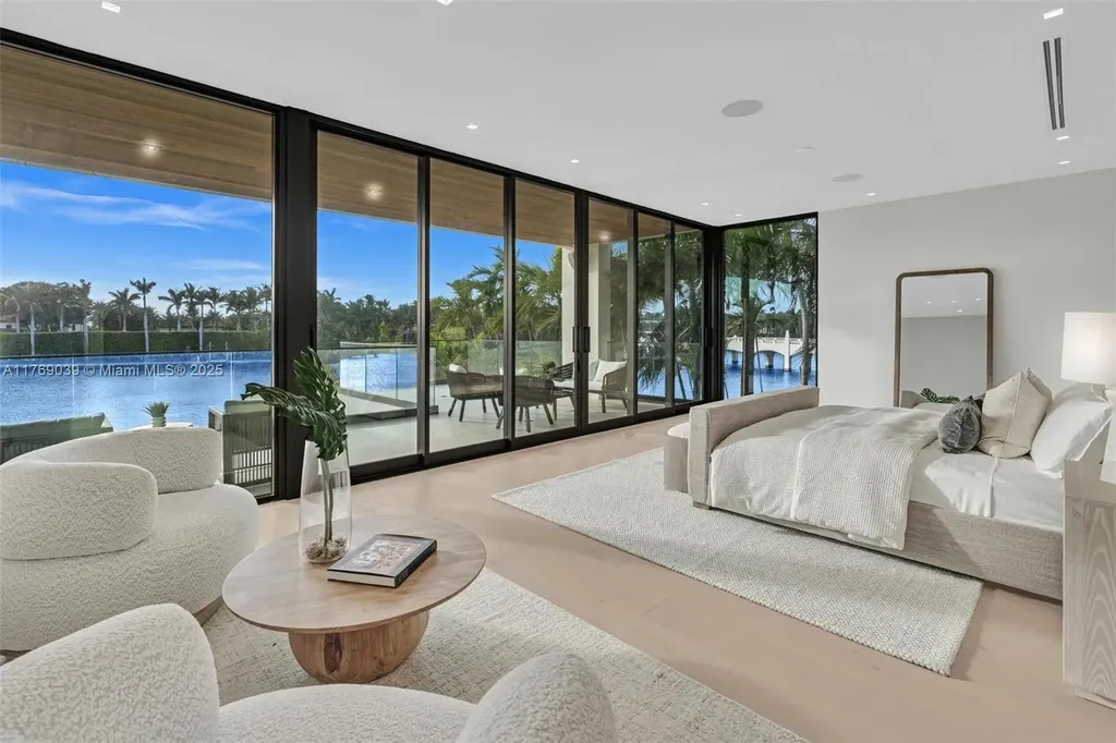 Open-concept living area with floor-to-ceiling windows at 9056 Bay Dr Surfside home for sale
