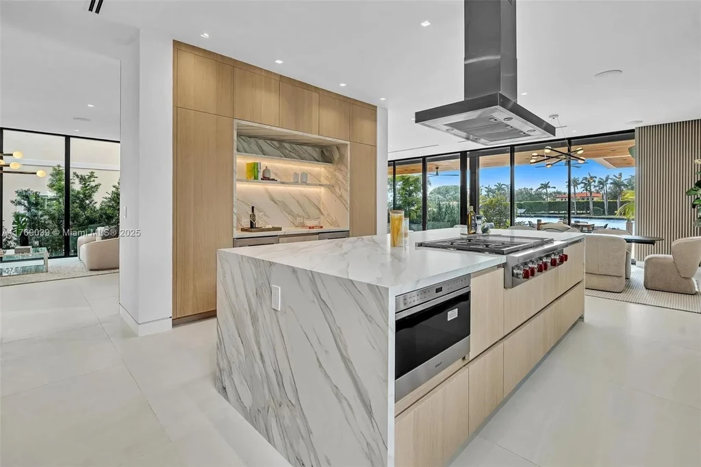 Open-concept living area with floor-to-ceiling windows at 9056 Bay Dr Surfside home for sale