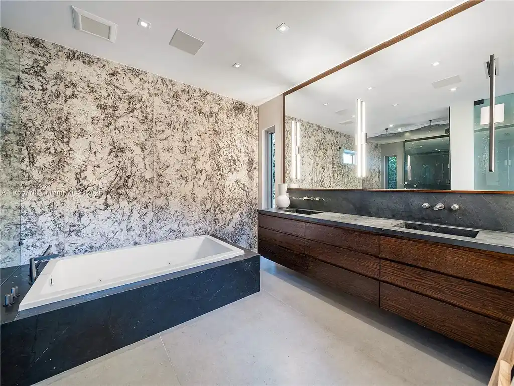 Modern open-concept living room in Miami Beach home for sale with custom stone finishes