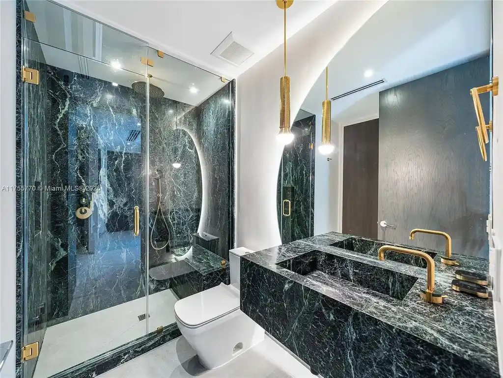 Modern open-concept living room in Miami Beach home for sale with custom stone finishes