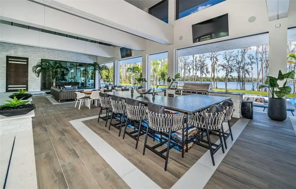 Infinity-edge pool designed by Ryan Hughes at 18725 Jiretz Rd with lake views and fiber optic lighting.