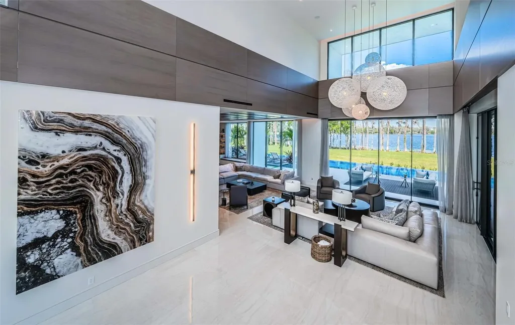 Infinity-edge pool designed by Ryan Hughes at 18725 Jiretz Rd with lake views and fiber optic lighting.