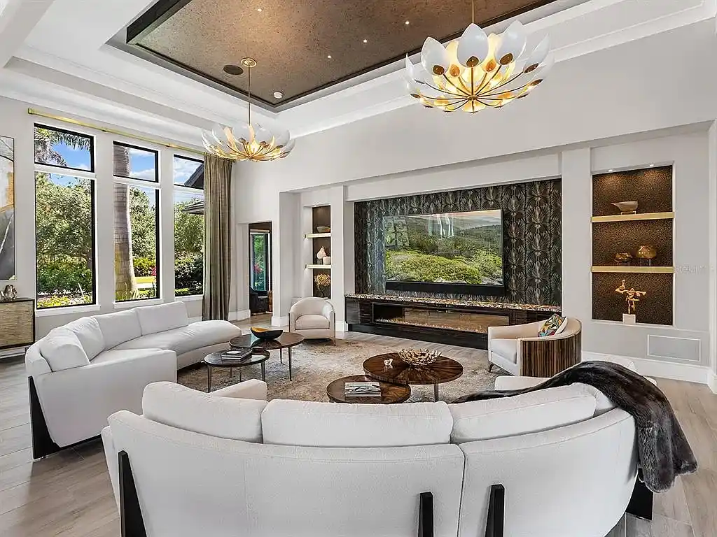 Front view of the stunning $7.5M custom lakefront estate at 18826 Ganton Ave in The Concession, Bradenton, showcasing grand circular driveway and elegant stone columns.