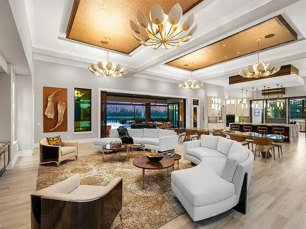 Front view of the stunning $7.5M custom lakefront estate at 18826 Ganton Ave in The Concession, Bradenton, showcasing grand circular driveway and elegant stone columns.