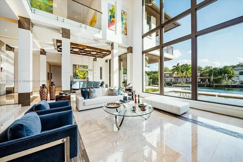 Luxurious waterfront mansion at 20 Compass Isle in Fort Lauderdale with tropical landscaping and gated driveway
