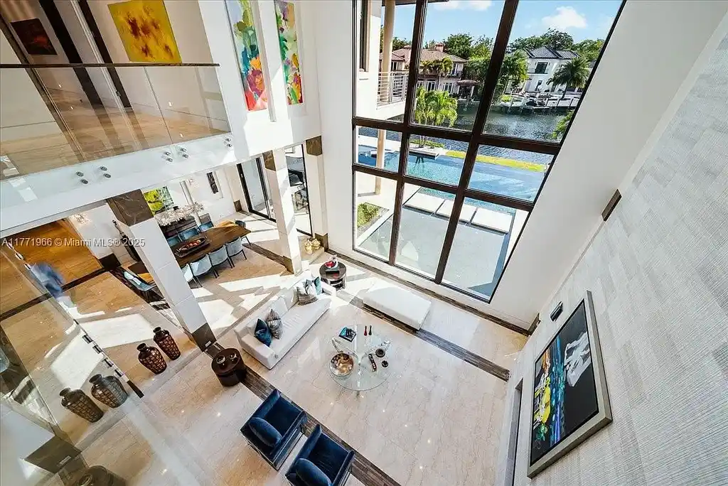 Luxurious waterfront mansion at 20 Compass Isle in Fort Lauderdale with tropical landscaping and gated driveway